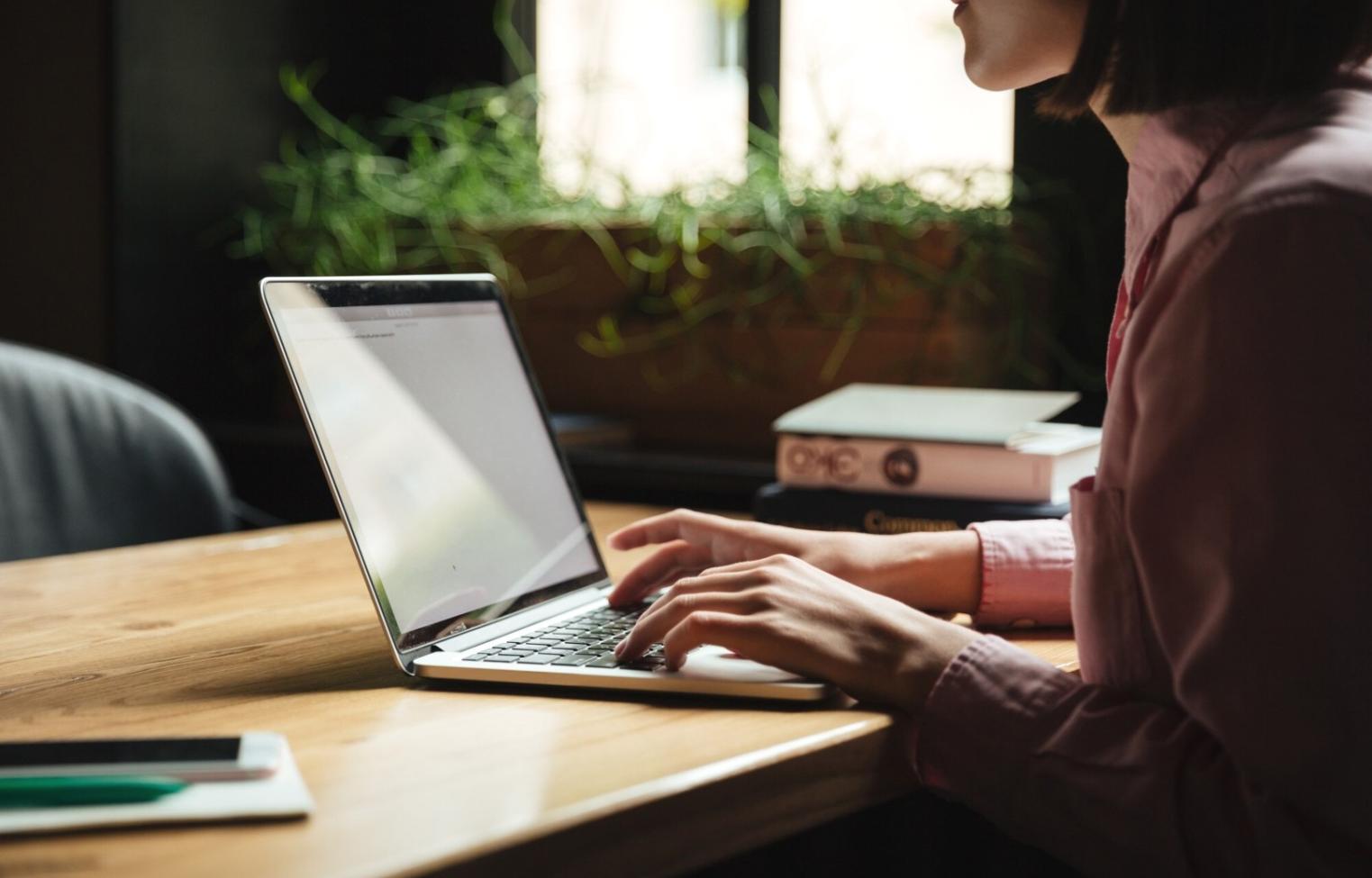 Business planning materials and laptop computer showing financial projections and growth strategies