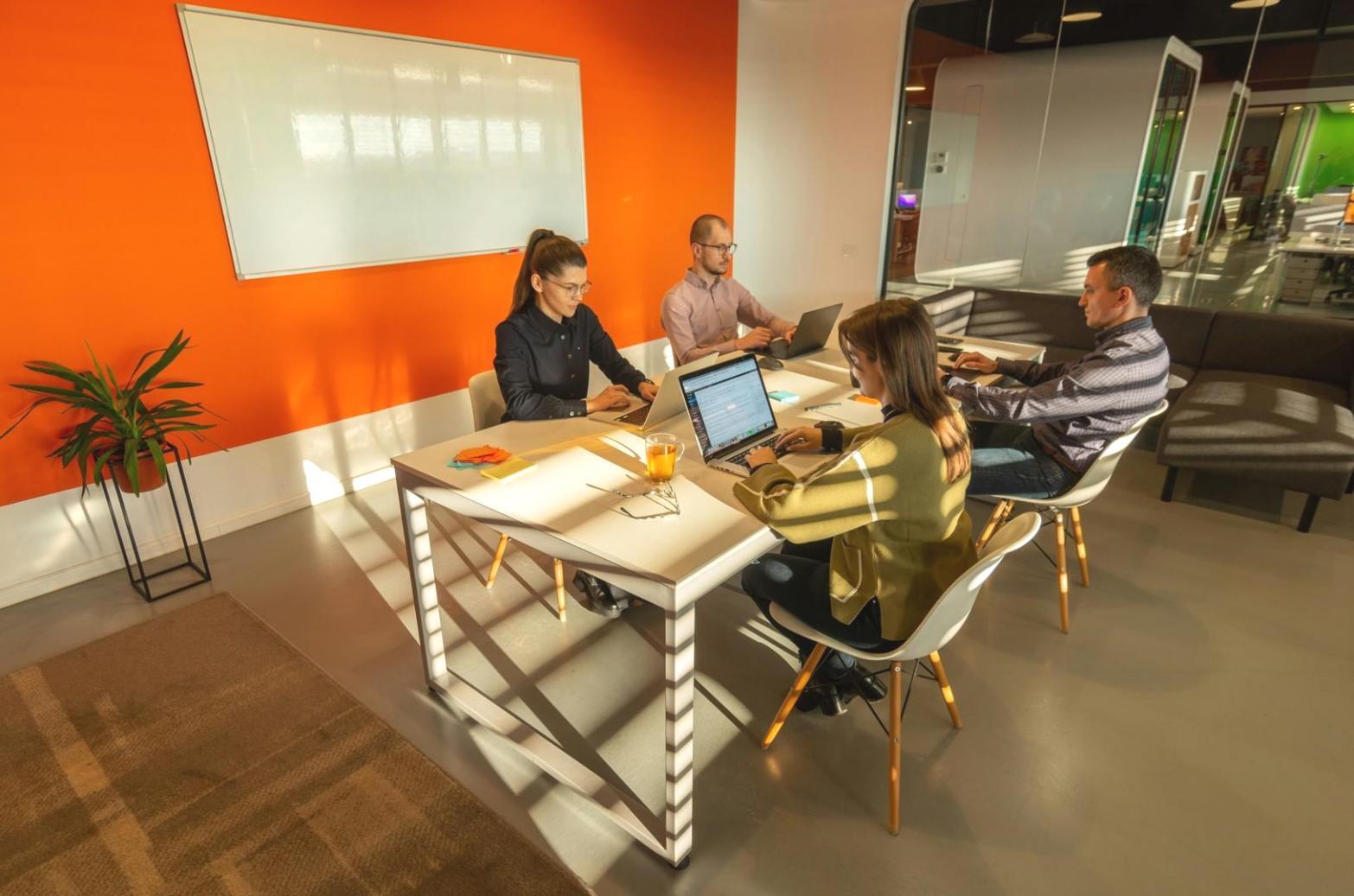 Business planning session with documents and charts spread across a conference table